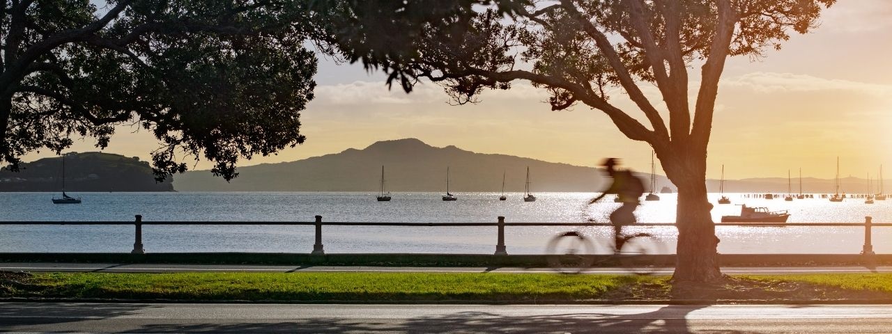 Man cycling at Tamaki Drive Mission Bay Auckland with sea views 