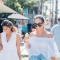 Two women eating ice creams on a sunny day